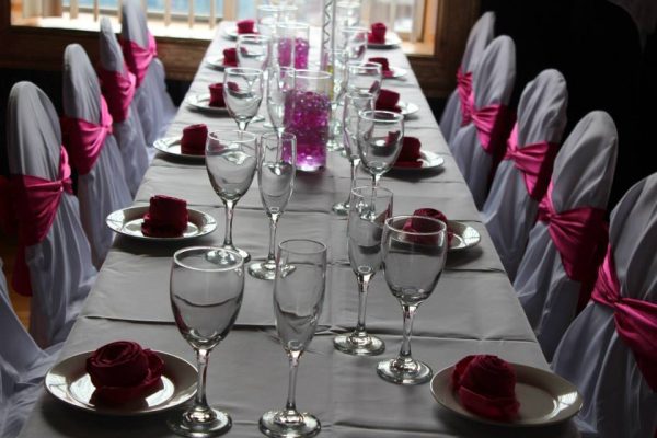 Dressed Chairs W Red Ribbon Event Table Setup Close Up